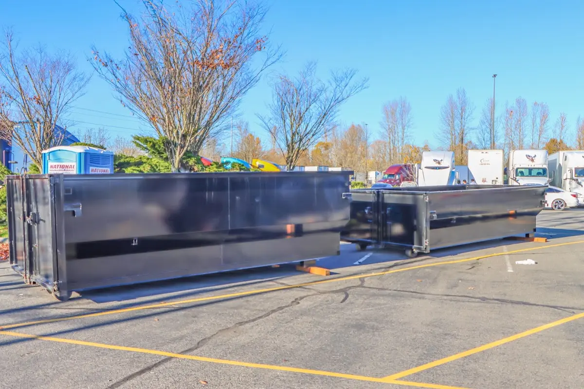 Professional dumpster rental service with roll-off container on residential driveway in Detroit